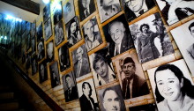 Stairs and wall with photos of Iraqi cultural workers